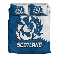 Front bedding view: blue duvet with 'SCOTLAND' text, crest emblem, two blue/white pillows