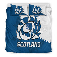Blue and white bedding set with crest circle, 'SCOTLAND' wordmark, and two matching pillows