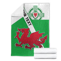 Folded green and white Wales football blanket with red dragon crest and Celtic knot