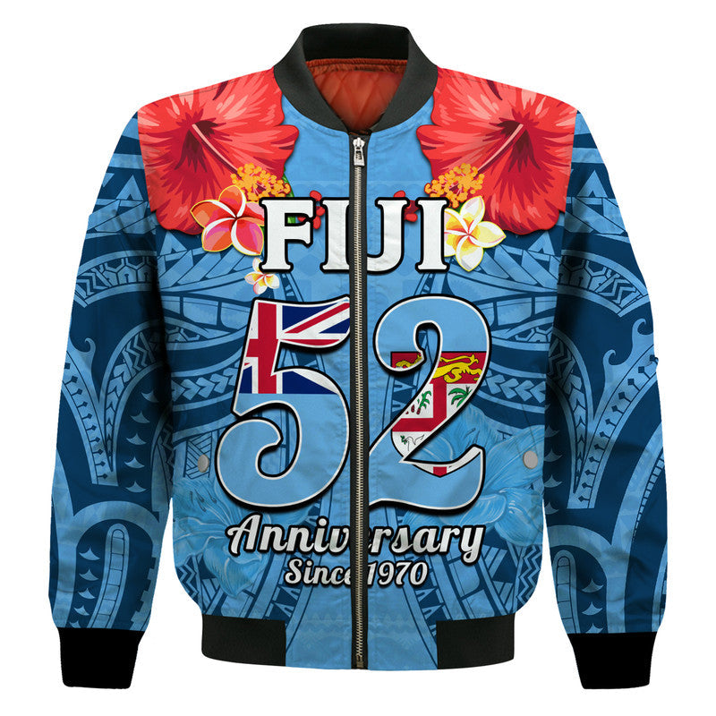 Blue bomber jacket front view, Fiji 52 anniversary print, red hibiscus accents
