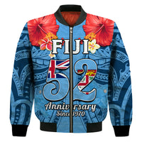 Blue bomber jacket front view, Fiji 52 anniversary print, red hibiscus accents