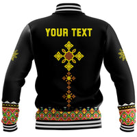 Black baseball jacket back with yellow "YOUR TEXT" and cross geometric print, ribbed hem