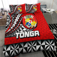 Red Tonga bedding set with two pillowcases, central crest emblem, black-and-white geometric bottom panel