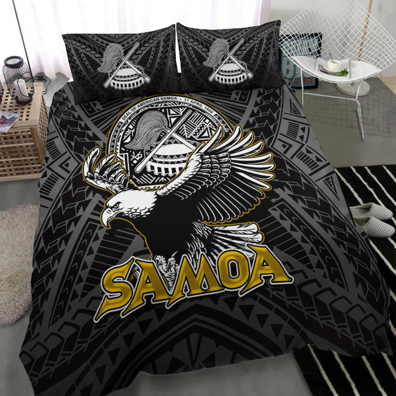 Black bedding set close view: Samoa logo with winged bird artwork on duvet and 2 pillows