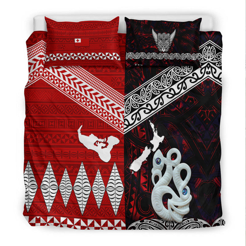 Bedding set shown flat: red geometric field, black patterned side, white octopus and emblem