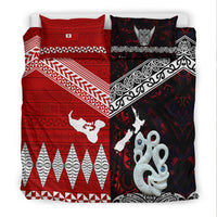 Bedding set shown flat: red geometric field, black patterned side, white octopus and emblem