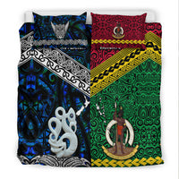 Two pillowcases and duvet with Aotearoa blue panel and Vanuatu red/green tiki artwork