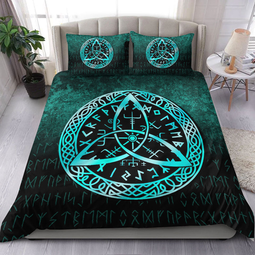 Teal duvet with cyan Vegvisir rune compass on black patterned bed shams