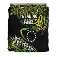 Top view bedding set on black background with green/yellow tribal print and two pillows
