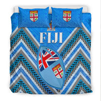Blue Fiji bedding set featuring heart graphic, shield crests on pillows, and chevron stripes
