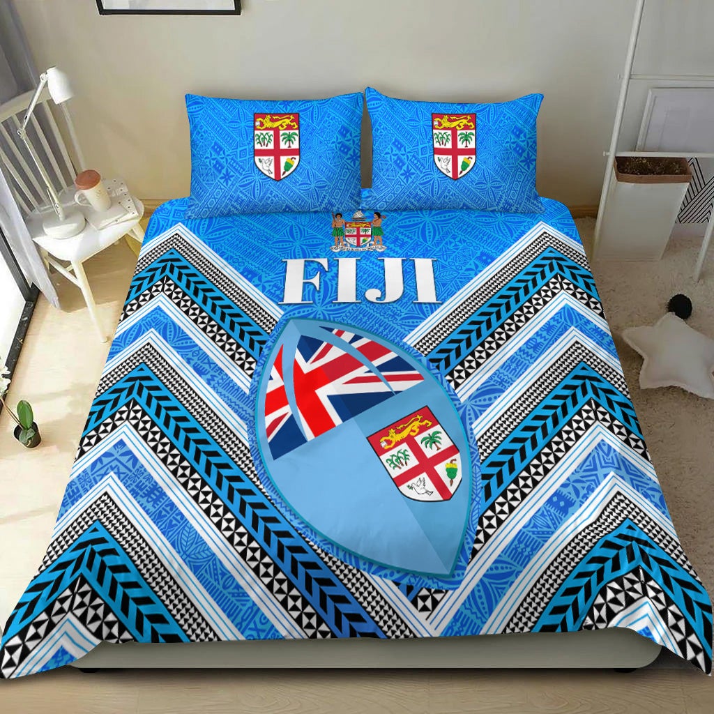 Blue Fiji bedding set with chevron stripes, shield emblems, and heart graphic on duvet