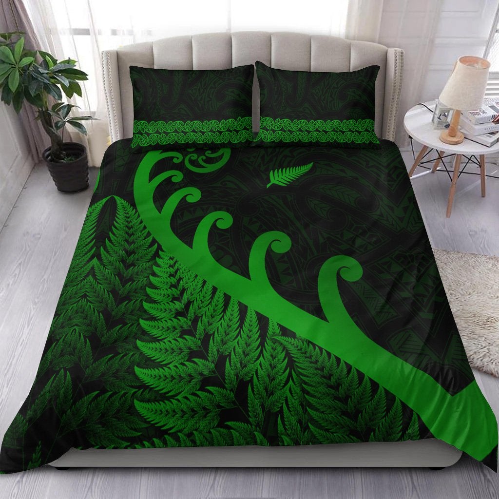 Green and dark bedding set with fern and koru patterns, two matching pillowcases