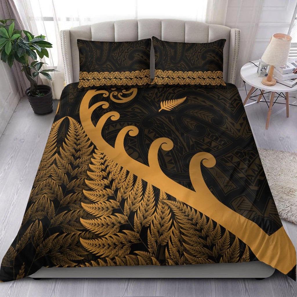 Black-and-gold duvet set with koru swirls, fern fronds, and Maori-inspired border trim