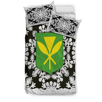 Bedding set shown from side: black floral duvet with green/yellow shield and two pillows