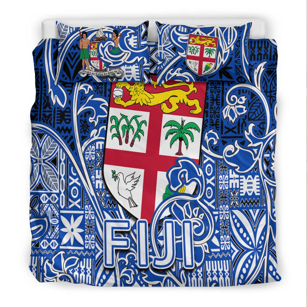 Front view: blue-and-white tapa duvet with Fiji crest shield, dove, palm, and “FJ”