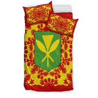 Stacked view of bedding set: red pillows and duvet with green shield emblem