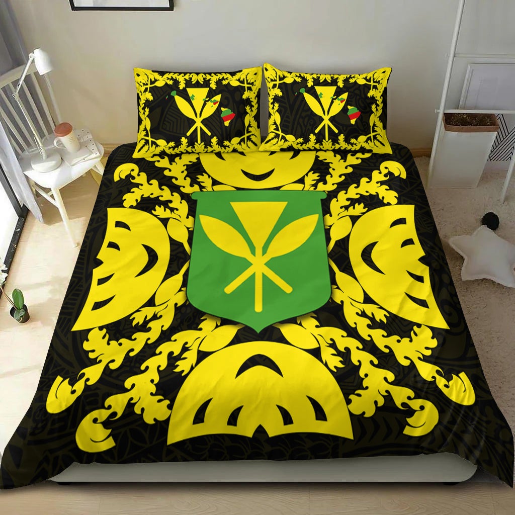 Black duvet and two yellow pillows with green emblem and tiki-style flame patterns