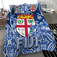 Blue/white tapa comforter with Fiji shield crest, palm trees, dove, and “FJ”