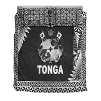Tonga bedding set close-up: black panel with crest and TONGA, tribal geometric edges