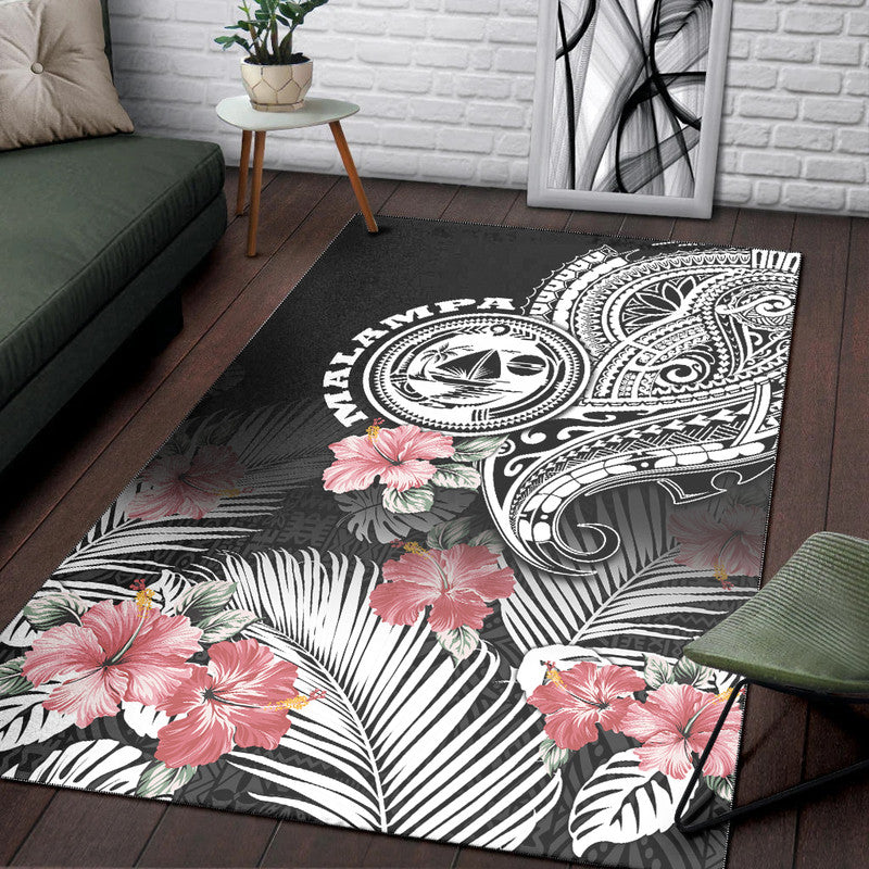 Black area rug with tribal tattoo medallions, pink hibiscus flowers, and palm leaf stripes