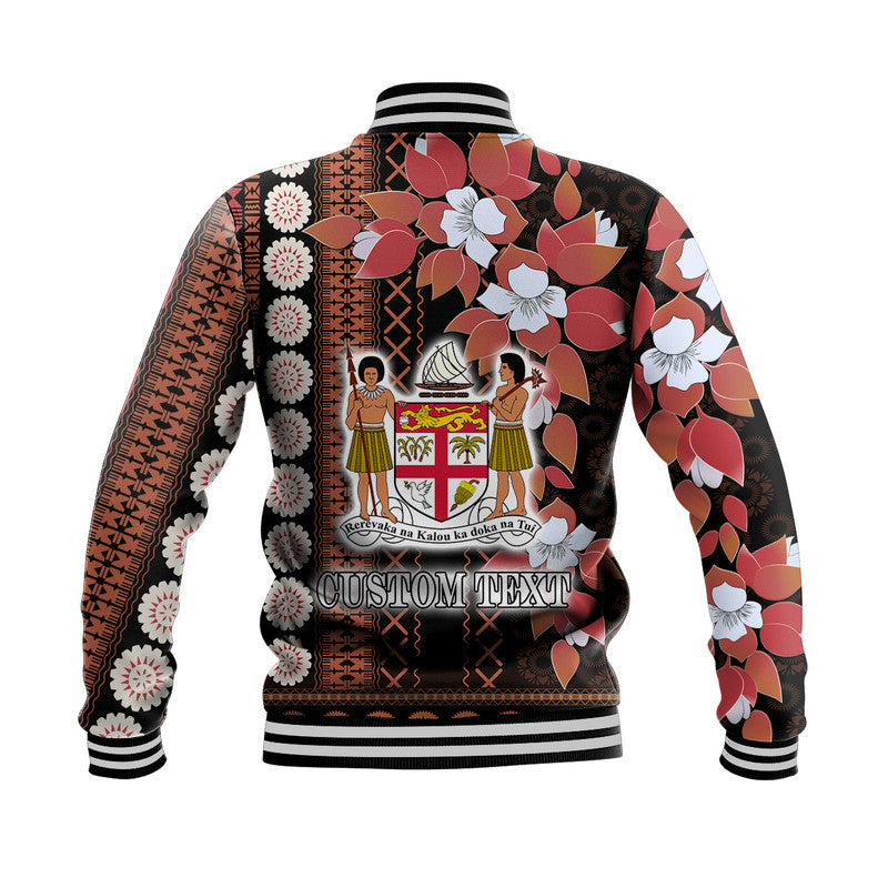 Back view: black unisex baseball jacket with floral tapa pattern and 'CUSTOM TEXT' print