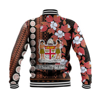 Back view: black unisex baseball jacket with floral tapa pattern and 'CUSTOM TEXT' print