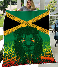 Green Rastafari lion blanket with multicolor kente bands, held outdoors