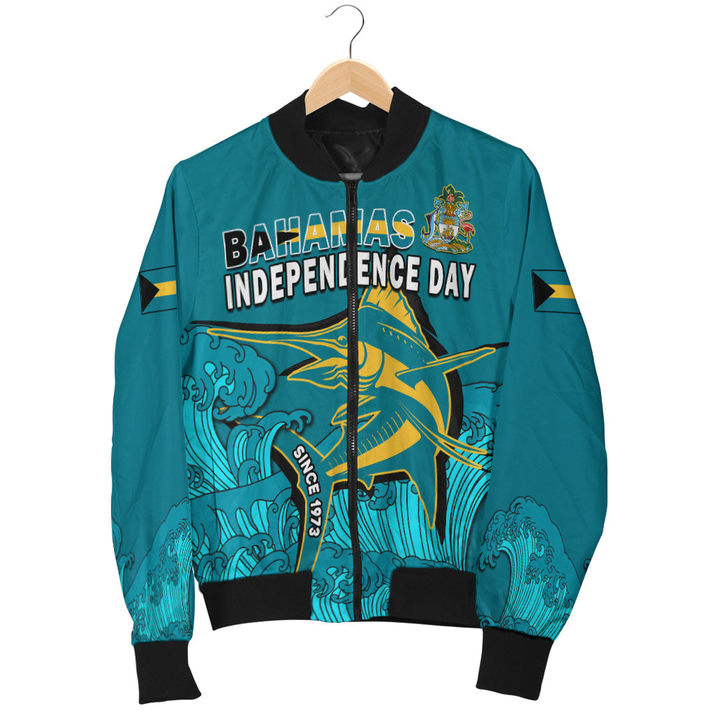 Teal-blue bomber jacket hanging on a hanger, Bahamas Independence Day front text and crest