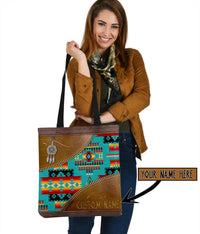Front view: multicolor native canvas tote with brown trim, black handles, “Your Name Here”