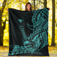 Black Hawaiian blanket with large turquoise ukulele, leaf and tiki motifs, spread out