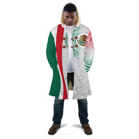 White hooded cloak with red and green vertical panels and Aztec eagle print on model