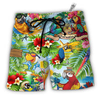 Parrot and tropical print Hawaiian shorts with colorful birds, flowers, and drinks