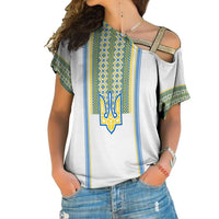 White cold-shoulder shirt with blue and yellow folk embroidery and central trident emblem