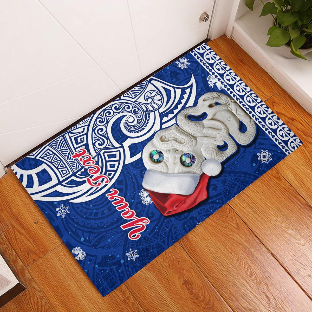 Blue Christmas door mat with Hei Tiki figure and Pohutukawa leaves design