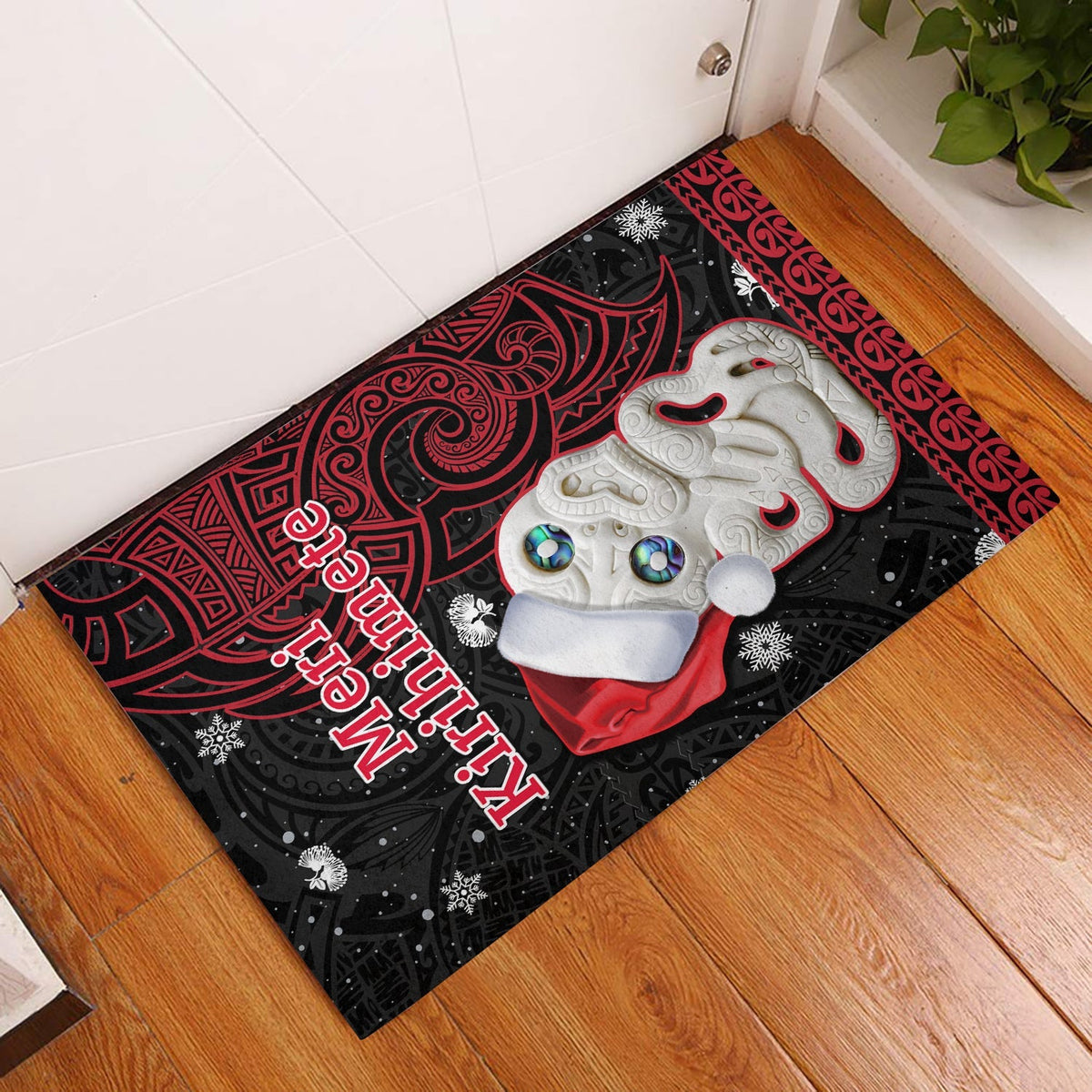 Christmas door mat with red and black Maori pattern and white Hei Tiki graphic