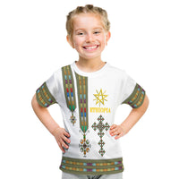 White kids T-shirt front with Ethiopian vertical stripe, 'ETHIOPIA' logo, and cross