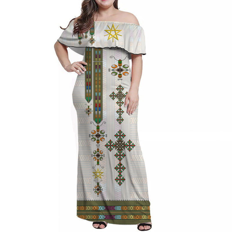 Off-shoulder long white maxi dress with colorful Ethiopian-style geometric print
