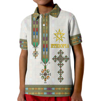 White polo shirt front close-up with vertical sash print, gold star, green/red diamonds