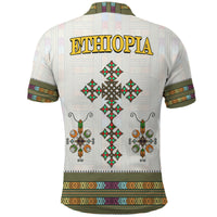 White polo shirt back with large ETHIOPIA text and diamond cross motifs, patterned hem