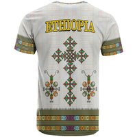 White Ethiopia T-shirt back with gold “ETHIOPIA” text and diamond cross ornament pattern