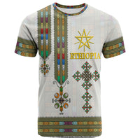 White Ethiopia T-shirt front with gold text, star emblem, and colorful tribal border stripes