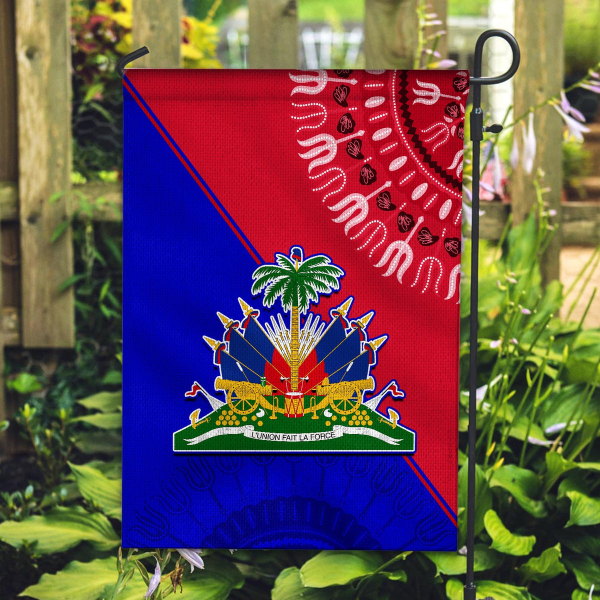 Haiti flag on stake, red-blue panels with central crest and wavy white motif