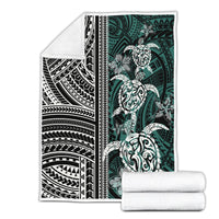 Folded Polynesian turtle blanket with floral motifs, black/white/green, with rolled matching blankets