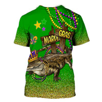 Green T-shirt with Mardi Gras wooden gate graphic and glitter trim