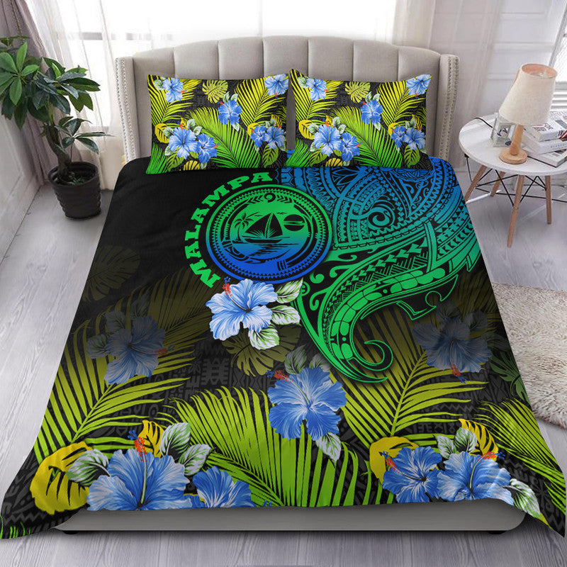 Gradient Vanuatu bedding set with blue hibiscus, green palms, tribal wave mask emblem
