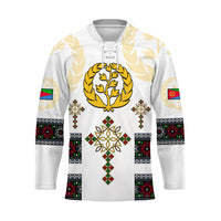 White Eritrea cross hockey jersey, gold laurel crest and patterned bands sleeves