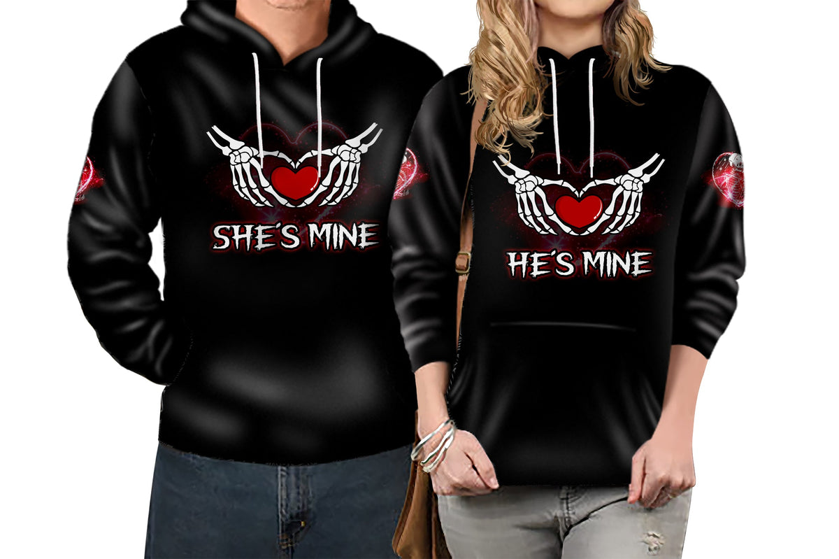 Black pullover hoodie with skull-heart ribcage graphic, 'She's Mine' and red sleeve accents