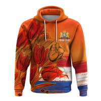 Orange pullover hoodie with tulip and Dutch crest graphic, white drawstrings