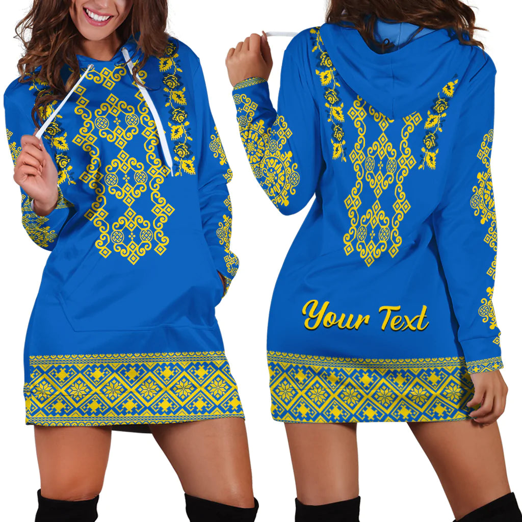 Blue hoodie dress with yellow Ukrainian-style embroidery, hood pocket and hem band.