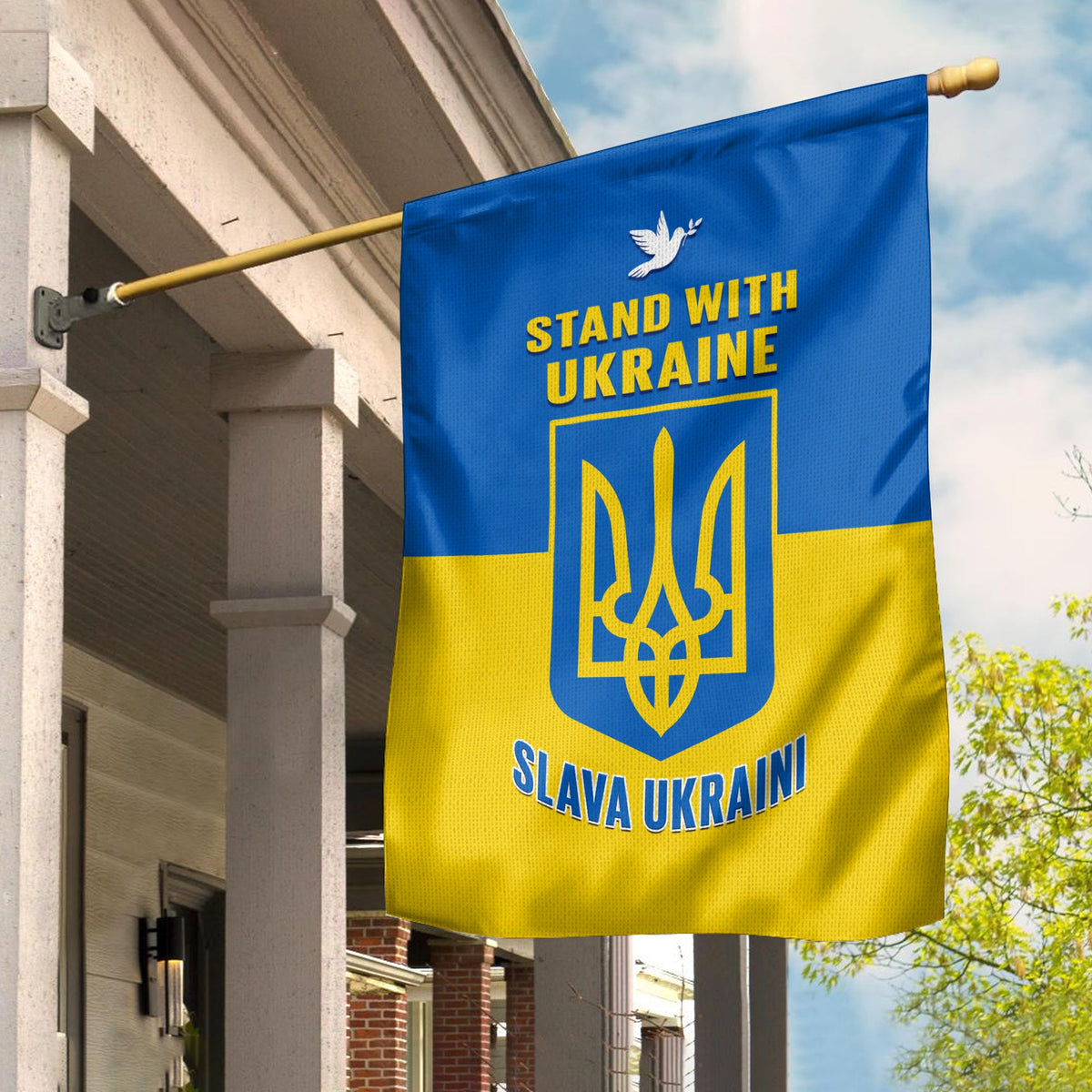 Ukraine flag garden banner on pole, blue/yellow with trident emblem and 'Stand with Ukraine'